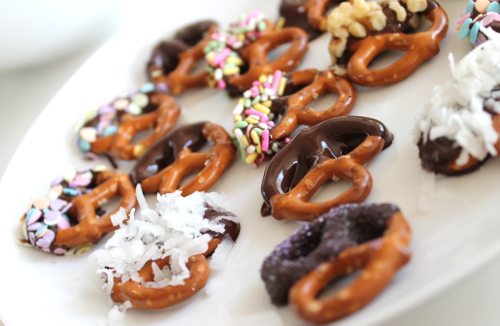 Special dark Hershey's chocolate dipped pretzels with coconut and sprinkles Lauryn Evarts, fitness and health blogger with dark chocolate dipped pretzels with coconut and chopped walnuts.
